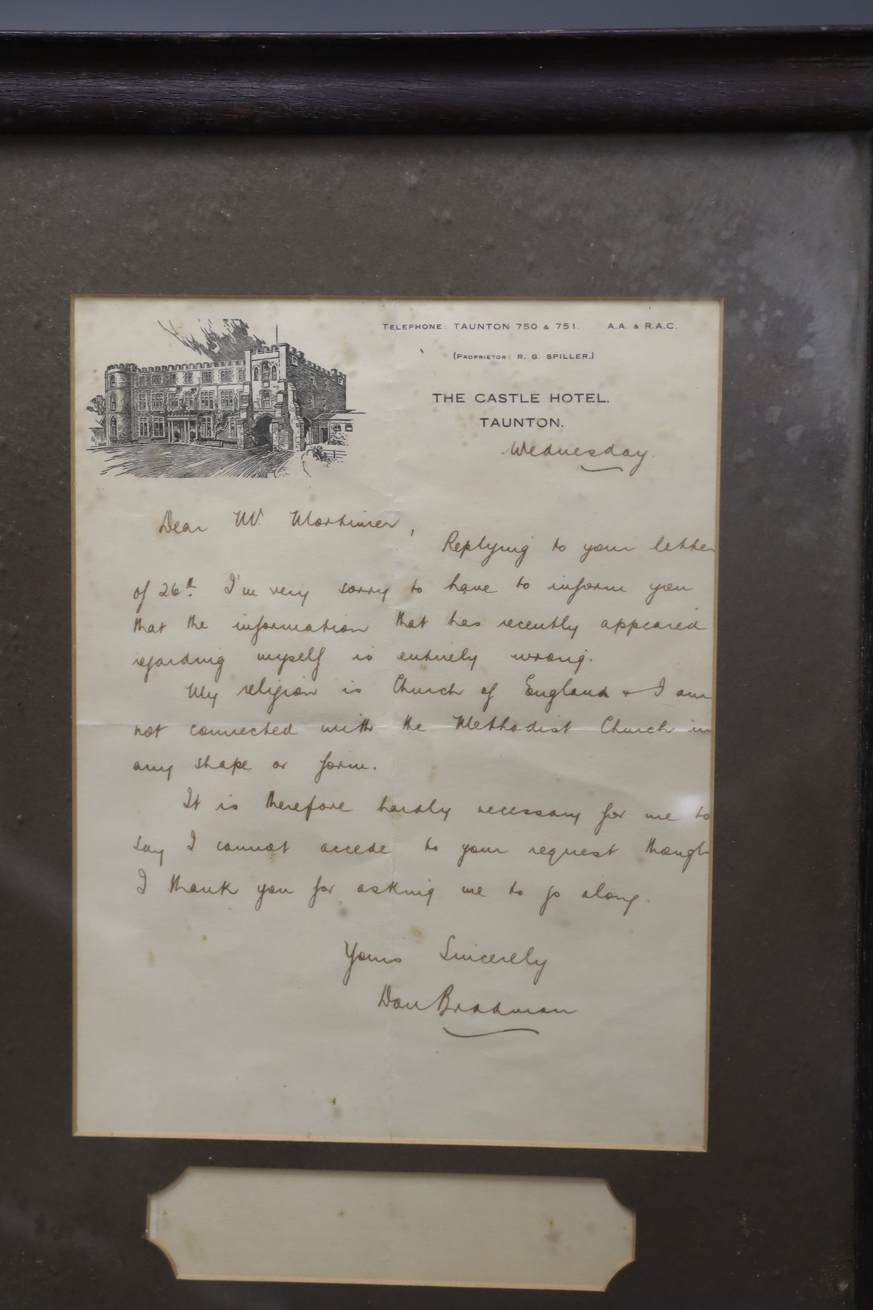 A signed letter written by Sir Don Bradman regarding his religion, framed